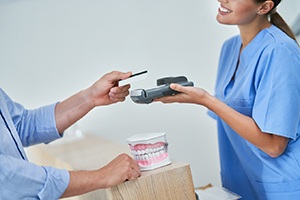 A patient paying the cost of their dental care