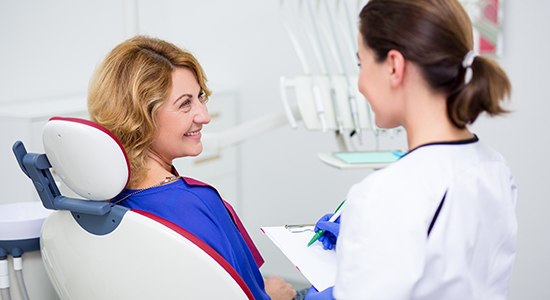 Dental patient talking to dental team member