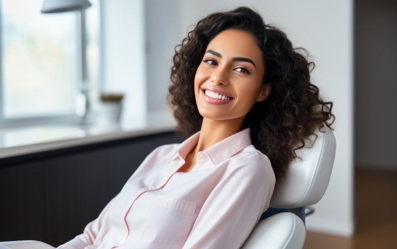 a woman smiling after receiving cosmetic dentistry